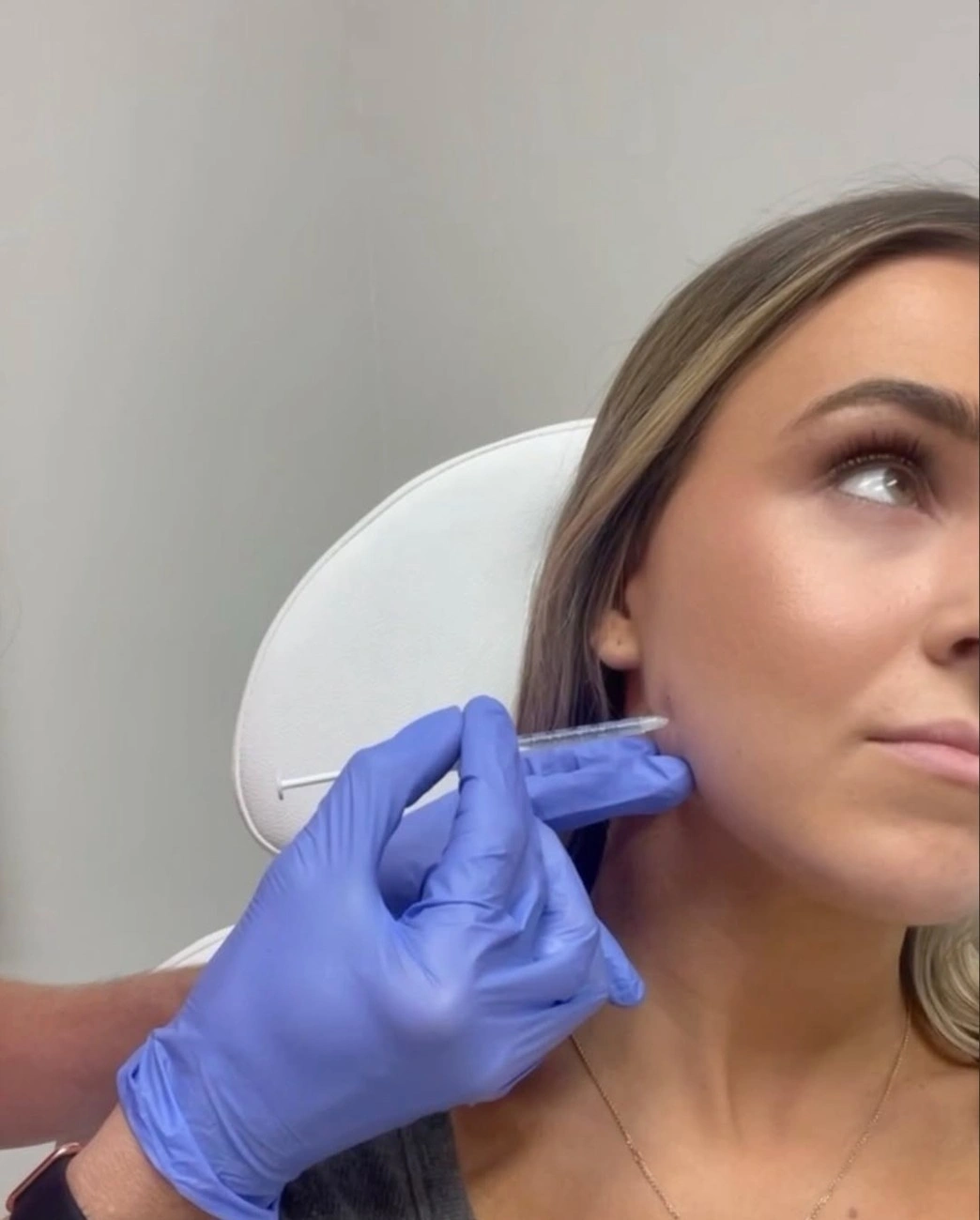 Girl getting injection in face